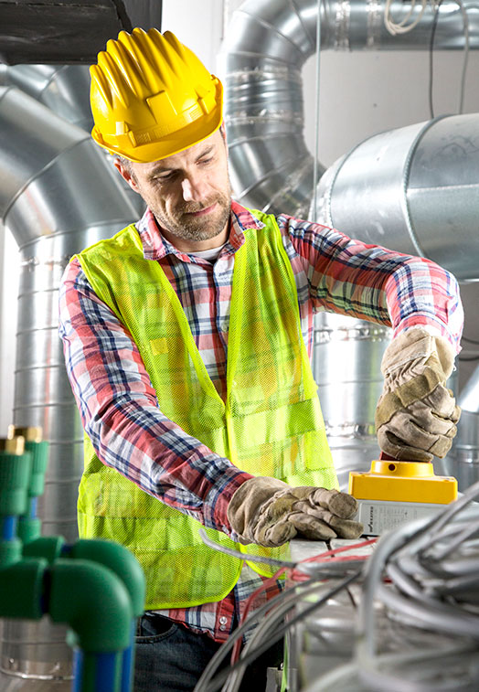 man in hardhat doing preventive maintenance